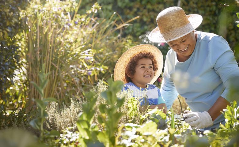 Grandmother gardening with grandchild