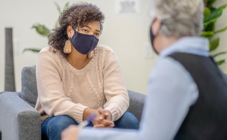 Woman with mask with psychologist