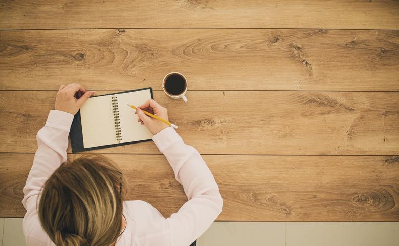 Woman writing in notebook