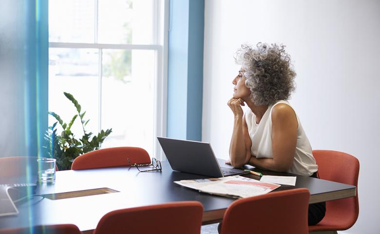 Middle-aged woman working on laptop