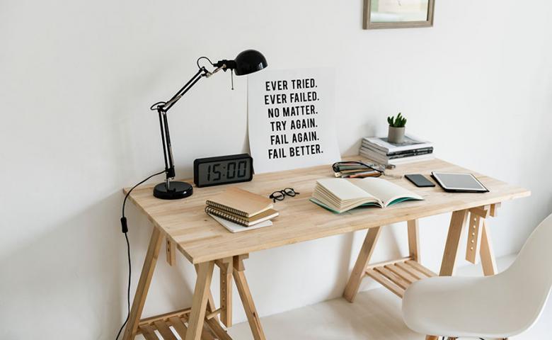 Fail sign on busy desk stating: Ever tried. Ever failed. No matter. Try again. Fail again. Fail better.