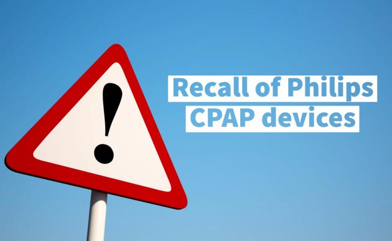 Red caution sign with blue sky background. Reads recall of Philips CPAP devices.
