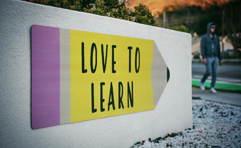 &quot;Love to Learn&quot; sign in the shape of a pencil