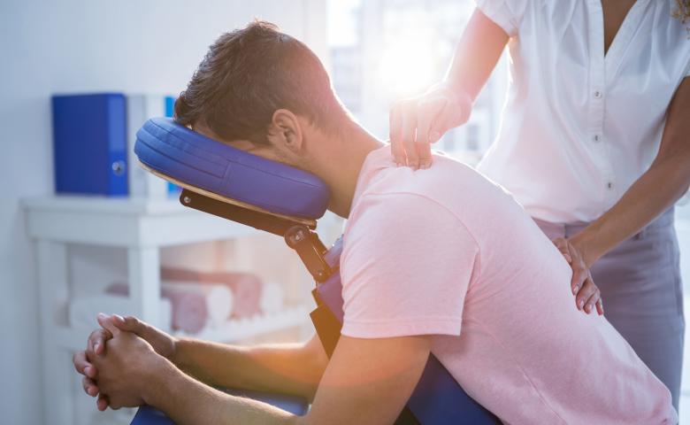 Physiotherapist performing treatment in a massage chair