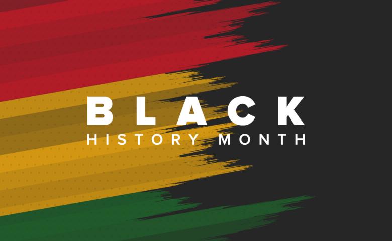 The words &quot;Black History Month&quot; written in white text on a black background with brushstrokes of the Pan-African colours of red, yellow, and green.